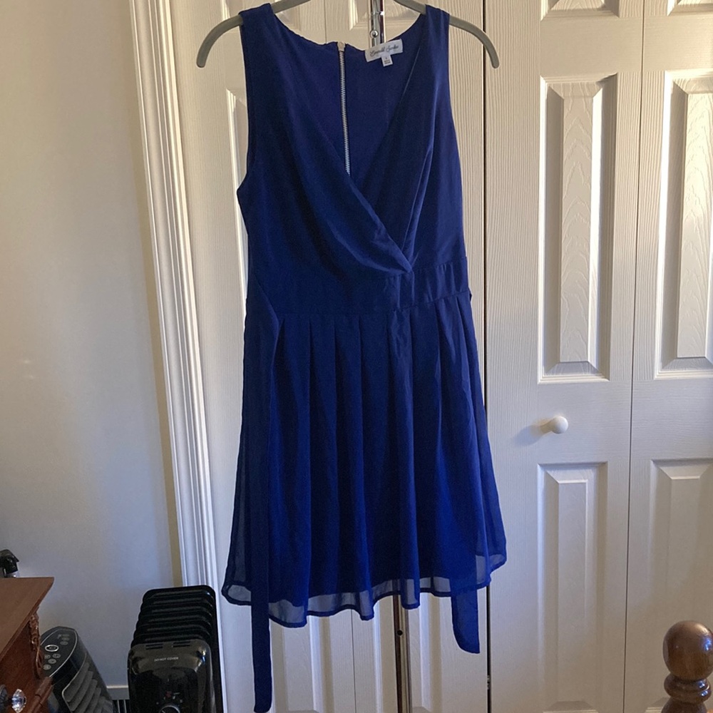 Navy blue pleated mini with sheer overlay and tie backs.